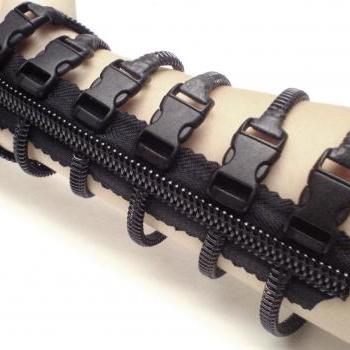 Steampunk cuff, zipper jewelry, black fingerless gloves.